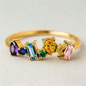 Close-up of geometric colorful ring with sparkling stones for women