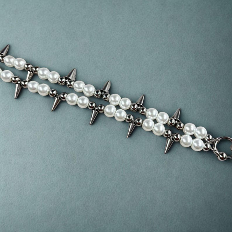 Side angle view of grunge pearl rivet necklace