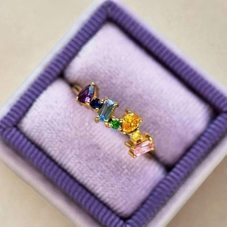 Rainbow stacking ring on purple velvet box, ideal for gift