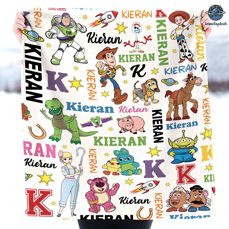 a person is holding a blanket with cartoon characters on it
