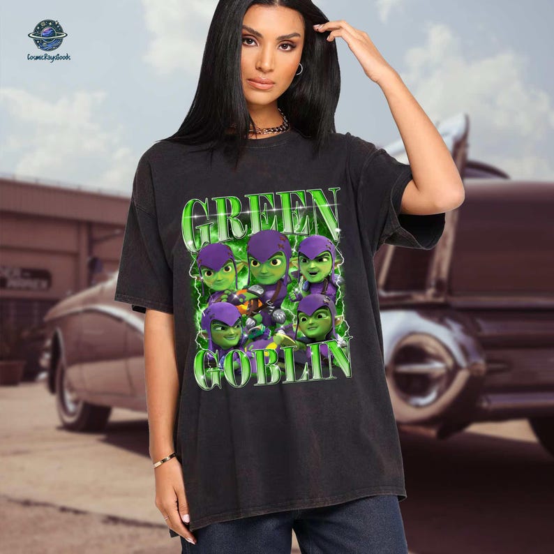 A woman wearing a black t-shirt with a graphic design featuring green and purple characters resembling the Green Goblin from the Spider-Man movies.