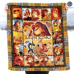 May include: A colorful blanket featuring characters and scenes from "The Lion King" movie. The design includes images of Simba, Mufasa, and other characters. The border has a zebra print and the words "Lion King".