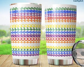 May include: Two white stainless steel tumblers with a rainbow pattern of the words "DONALD TRUMP" repeated. The tumblers have a silver base and lid, set against a blurred outdoor backdrop.