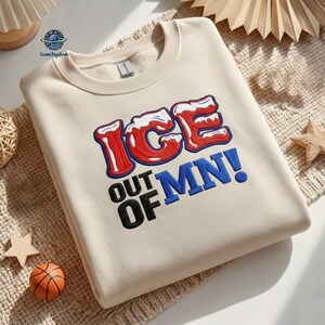 May include: Cream-colored sweatshirt with the text "ICE OUT OF MN!" in red, white, and blue. The sweatshirt is made of a soft material and is perfect for casual wear.