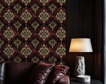 May include: A dark red leather sofa with two pillows in a living room with a patterned wallpaper featuring a burgundy and gold design. A lamp with a white shade and a stone base sits on a black side table.