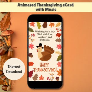 May include: A smartphone displays a Thanksgiving eCard with a cartoon turkey wearing a hat, surrounded by autumn leaves. The card reads "Wishing you a day filled with love, laughter, and gratitude" and "Happy Thanksgiving!" The words "Animated Thanksgiving eCard with Music" are at the top.
