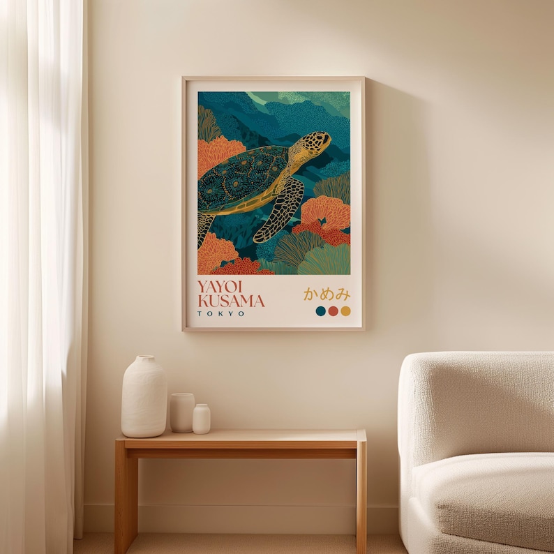Framed art print of a sea turtle in a vibrant underwater coral scene, hanging on a beige wall above a cream armchair with a curtain beside it.