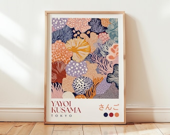 May include: A framed art print featuring a colorful abstract design with coral-like shapes in shades of orange, yellow, purple, and blue. The print includes the text "YAYOI KUSAMA TOKYO" and Japanese characters. The artwork is displayed on a wooden floor.