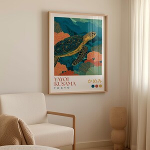 Framed sea turtle print on a beige wall above a wooden bench with ceramic vases, styled in a calm minimalist interior.