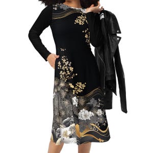 May include: A black long-sleeved dress with a floral pattern in gold, white, and gray. The dress features a knee-length skirt and is paired with a black leather jacket. The design incorporates Japanese-inspired motifs.