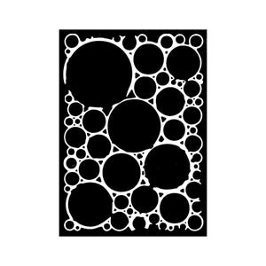 May include: A black and white stencil design featuring a pattern of overlapping circles of varying sizes. The circles are solid black, outlined with white, creating a high-contrast, graphic effect. The design is rectangular.