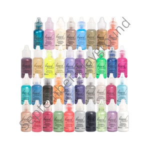 May include: A collection of 36 small bottles of Liquid Pearls Dimensional Pearlescent Paint. The bottles are arranged in rows of six, with each bottle featuring a different color of pearlescent paint. The colors include: Ballerina, Brass, Brilliant, Bronzi, Copper Pearl, Coral, Marigold, Lightning, Lemon Chiffon, Platinum Lace, Gold Pearl, Electric, Mermaid, Onyx,  Iris,  Deep Water,  Prairie,  Sage,  Thriving,  Silver Pearl,  Slate,  Succulent,  Taffy,  White Opal, and more.