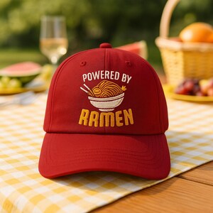Powered by Ramen Embroidered Hat – Funny Noodle Lover Cap, Ramen Gift for Foodies, Adjustable Wash Cap, Baseball Cap, or 2-Tone Hat