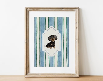 May include: Framed watercolor print featuring a dachshund dog illustration. The dog is black and brown, set against a striped background of blue and green vertical lines. The artwork is in a decorative frame.
