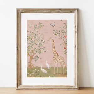 May include: Framed art print featuring a giraffe, two white birds, and butterflies in a whimsical garden scene. The artwork has a pink background with trees and apples. The frame is a light brown color.
