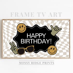 May include: A printable birthday banner with a checkered background. The banner features a black and white happy birthday message with a smiley face, sunglasses, and a hand gesture.