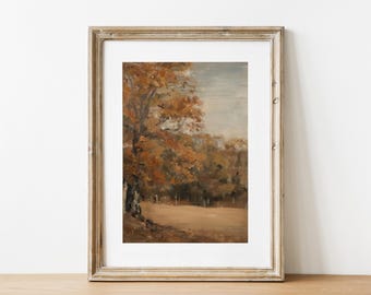 Puede incluir: Una pintura de paisaje enmarcada representa una escena otoñal serena. La obra presenta un gran árbol con hojas naranjas y marrones, un campo y un cielo apagado. El marco es de madera clara y desgastada.