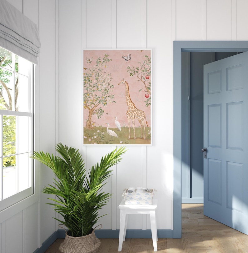 May include: A framed art print featuring a giraffe, birds, and butterflies in a whimsical garden scene. The artwork has a pink background with trees and flowers. The print is displayed in a white frame, adding a touch of elegance to the room.