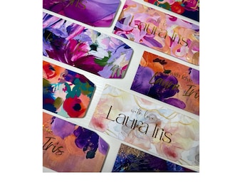 May include: A collection of colorful gift tags with floral watercolor designs in shades of purple, pink, and gold. Some tags feature the names "Laura Iris" and "Tris" in gold script, along with the phrase "with love."