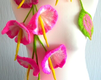 May include: A pink and white felt flower necklace with green stems and leaves. The necklace is displayed on a white mannequin.
