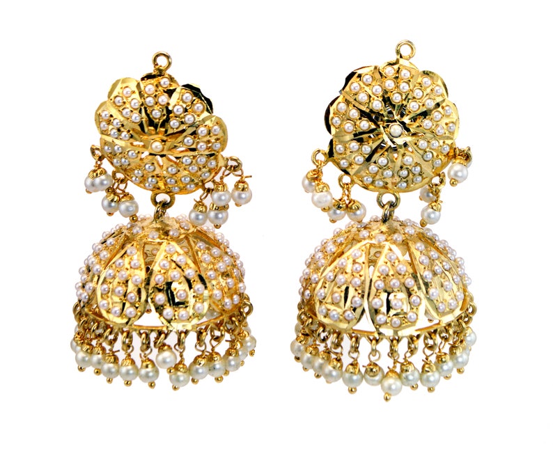 May include: A pair of gold earrings with pearl accents. The earrings are in the shape of a bell with a round, decorative top.
