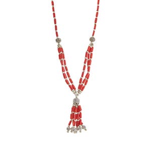 May include: A red coral beaded necklace with a tassel and silver accents.