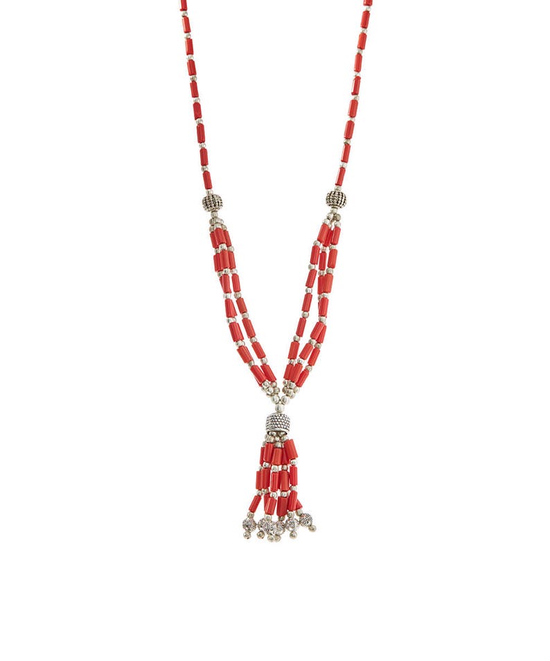 May include: A red coral beaded necklace with a tassel and silver accents.