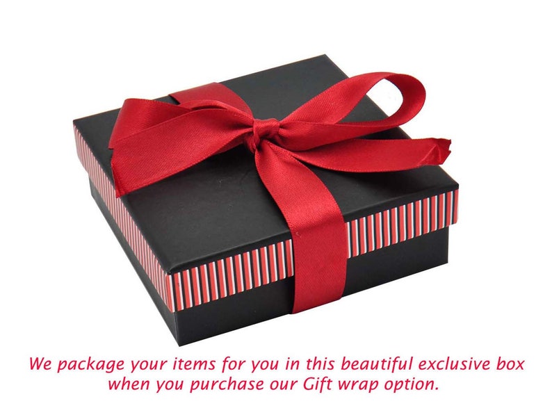 May include: A black gift box with a red ribbon tied in a bow. The box has red and white stripes around the edges.