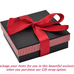 May include: A black gift box with a red ribbon tied in a bow. The box has red and white stripes around the edges.