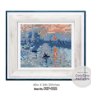 Puede incluir: Un patrón de punto de cruz de un paisaje marítimo con una puesta de sol y barcos. El patrón está en un marco blanco con un borde azul. El patrón tiene 40 puntos de ancho y 34 puntos de alto. El patrón se llama "CEP-022" y está disponible en Etsy.