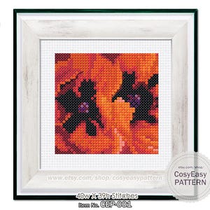 May include: Framed cross-stitch art featuring a floral design in shades of orange, red, and black. The artwork is in a white frame with a green border. The text "40w X 39h Stitches" and "Item No. CEP-001" are visible. The Etsy shop name "CosyEasy PATTERN" is also displayed.