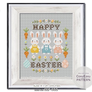 May include: Cross stitch pattern featuring three white bunnies with colourful Easter outfits, surrounded by flowers and carrots. The text "HAPPY EASTER" is displayed above the bunnies. The pattern is 62 stitches wide and 73 stitches high.