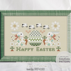 Peut inclure: Un motif de point de croix encadré dans un cadre vert. Le motif présente deux lapins blancs, un œuf de Pâques, des carottes, des fleurs et les mots "Happy Easter". Le motif mesure 121w X 71h points.