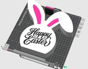 May include: White 3D printed bunny rabbit head with pink ears and the text "Happy Easter" in black script font.