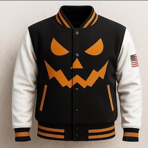 May include: Black varsity jacket with white sleeves and a jack-o'-lantern face design in orange. The jacket features an American flag patch on the sleeve and orange and black striped trim at the collar, cuffs, and hem. A button-up closure completes the design.