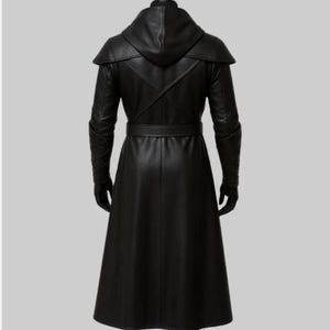 May include: A long, black leather coat with a hood, belt, and gloves. The coat has a sleek, tailored design with a flowing skirt. The sleeves have a unique armored look. The coat is shown from the back.