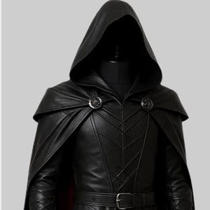 May include: A black leather hooded cloak and jacket ensemble. The cloak features a cape and is fastened with two decorative clasps. The jacket has a belt and intricate stitching details. The outfit is displayed on a mannequin.