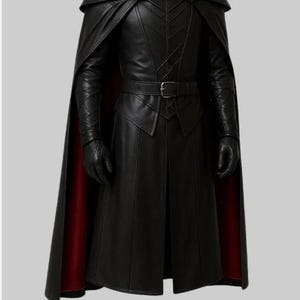 May include: A black leather costume with a long coat, cape, and gloves. The cape has a red lining. The costume features a belt with a silver buckle and intricate stitching details. The outfit is designed for cosplay or themed events.