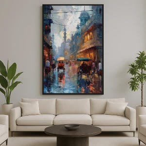 May include: An abstract painting of a city street scene with rickshaws and buildings. The artwork features a color palette of blues, oranges, and browns, with a focus on light and shadow. The painting is framed in a black frame.