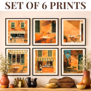 May include: Set of 6 framed prints featuring vibrant orange and yellow buildings with awnings, tables, and chairs. The prints depict scenes of cafes and shops, with the text "SET OF 6 PRINTS" at the top.