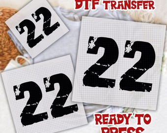 May include: Three DTF (Direct to Film) transfer sheets with the number 22 in a distressed black font. The transfers are on a grid-lined paper. The words "DTF TRANSFER" and "READY TO PRESS" are in red, heart-shaped text.