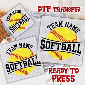 May include: Softball DTF transfer designs featuring a yellow softball with red stitching and the words "Team Name" and "Softball" in black. The phrase "Ready to Press" is also visible in red.