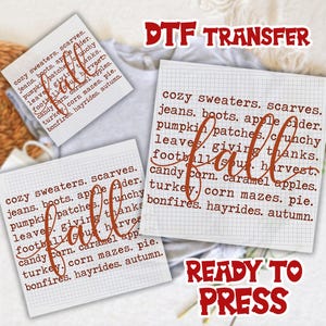 May include: A DTF transfer sheet featuring a grid pattern background with the word fall written in a large cursive script over a list of autumn-themed words including cozy sweaters, scarves, jeans, boots, apple cider, pumpkin patches, and bonfires.