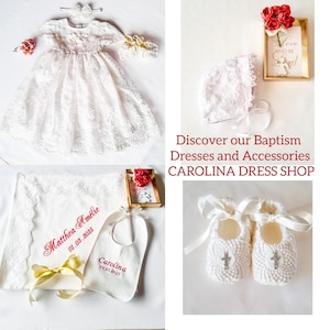 May include: White lace christening gown with a matching bonnet, embroidered bib, and booties. The gown has a delicate lace pattern and a full skirt. The set also includes a white blanket with lace trim and a personalized embroidery.