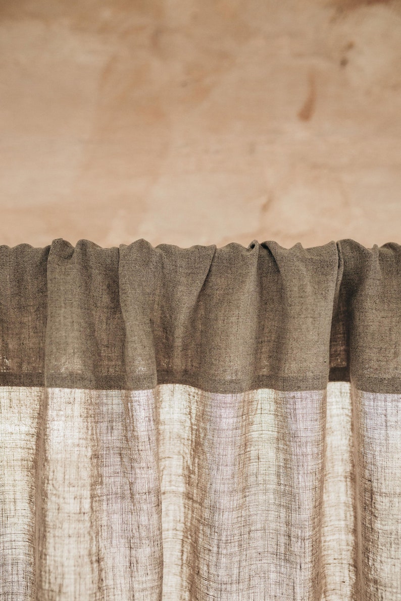 May include: A pair of brown linen curtains with a white linen lining. The curtains are gathered at the top and hang straight down.