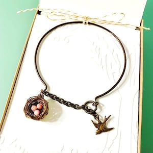 Personalized bird nest bracelet with Peruvian pink opals, inspired by the Carolina wren. Pick your choice of eggs and initials charms!