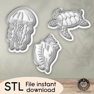 May include: Three white, stylized cookie cutters: a jellyfish, a sea turtle, and a seashell. The image includes the text "STL File instant download" and a logo with the text "Lovely Creations".