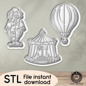 Könnte beinhalten: Drei 3D-gedruckte Ausstecher, einer mit einem Clown, einer mit einem Zirkuszelt und einer mit einem Heißluftballon. Die Ausstecher sind weiß und haben eine glatte, glänzende Oberfläche.