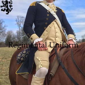 May include: A navy blue regimental uniform with gold accents, epaulets, and buttons. The uniform includes a cream-colored vest, breeches, and a white sash. The text "Regimental Uniform" is visible on the image.