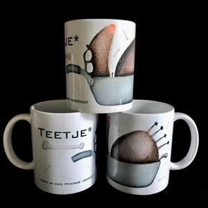 May include: Three white ceramic mugs with whimsical illustrations. Each mug features a cartoon character in a cooking pot, with the text "TEETJE*" and German phrases. The mugs have a handle and are set against a black background.